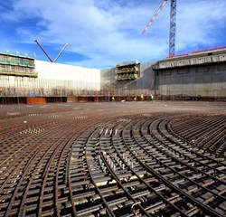 Two of the emblematic construction projects on the ITER platform in late 2013: a winding facility for the massive poloidal field coils (in red) and the Cryostat Workshop (at right). (Click to view larger version...)